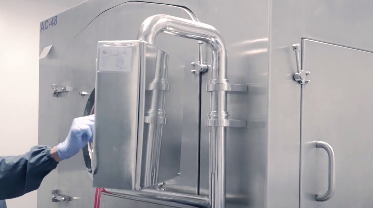 A closer view of stainless-steel equipment on the facility floor.