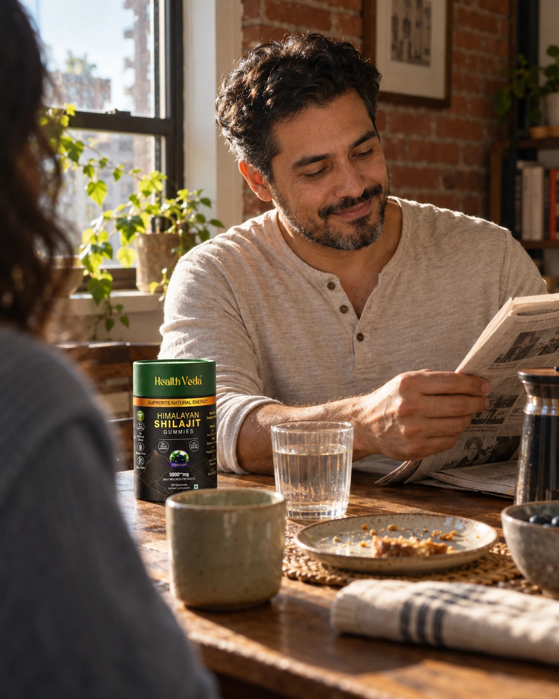 Lifestyle illustration of a man reading over breakfast with a Shilajit container on the table
